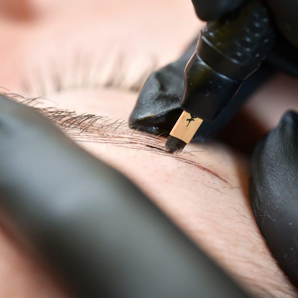 Microblading eyebrows, getting facial care and tattoo at beauty salon