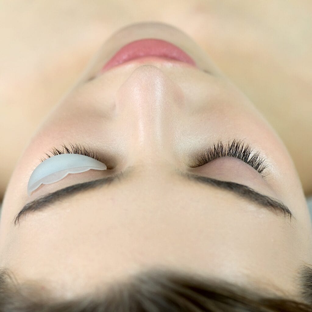 Close up of beauty model's face with perfect fresh skin and long eyelashes, lash lift laminate botox procedure.